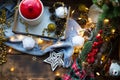 Christmas decor by the window on a cozy wooden windowsill with a mug with a drink and a cookie jar. Fairy lights, Christmas tree