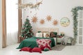 Christmas decorated bedroom in classic green and red colors. Classic Christmas tree decorations Royalty Free Stock Photo