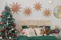 Christmas decorated bedroom in classic green and red colors. Classic Christmas tree decorations Royalty Free Stock Photo