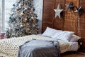 Christmas decorated bedroom interior with comfortable bed Royalty Free Stock Photo