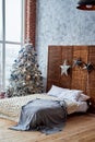 Christmas decorated bedroom interior with comfortable bed. Royalty Free Stock Photo