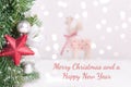 Christmas decorated fir branches with blurred background and a text Merry Christmas