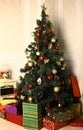 Christmas decorated tree and presents cozy corner room Royalty Free Stock Photo