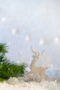 Christmas decoration on abstract twinkling lights background, soft focus. Silver deer on the snow against a background of blurry l Royalty Free Stock Photo