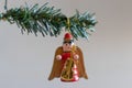 Christmas decoration. Angel with a guitar hanging on a green Christmas tree branch. Royalty Free Stock Photo