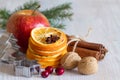 Christmas decoration with apple, dried orange, cinnamon, nuts and cranberry