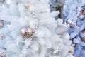 Christmas decoration, artificial white Christmas tree with a golden ball. Festive background Royalty Free Stock Photo