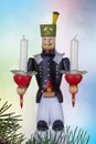 Christmas decoration background. Closeup of a christmas vintage wooden traditional figurine with two candles against abstract