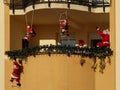 Christmas decoration on the balcony, Santas climbing on the ladders