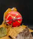 Christmas decoration ball decorated with autum leafs