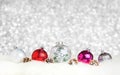 Christmas decoration ball on white fur at silver bokeh light background,Holiday greeting card Royalty Free Stock Photo