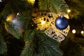 Christmas decoration balls branch. Christmas tree toy on spruce branches. Blue, gray, shiny toy ball and pine cone on the