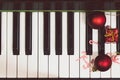 Christmas decoration balls, lollipops, candies, gift boxes placed on the piano in the top view corner give the feeling of Royalty Free Stock Photo