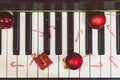 Christmas decoration balls, lollipops, candies, gift boxes placed on the piano in the top view corner give a feeling of Christmas Royalty Free Stock Photo