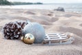 Christmas decoration balls on sandy beach. Royalty Free Stock Photo