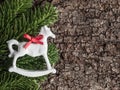 Christmas decoration on bark, evergreens, rocking horse