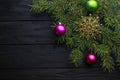 Christmas decoration baubles with branches of fir tree on wooden background Royalty Free Stock Photo