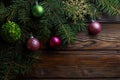 Christmas decoration baubles with branches of fir tree on wooden background Royalty Free Stock Photo