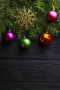 Christmas decoration baubles with branches of fir tree on wooden background Royalty Free Stock Photo