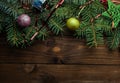 Christmas decoration baubles with branches of fir tree on wooden background Royalty Free Stock Photo