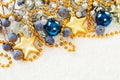 Christmas decoration border with gold star and blue glass balls on white snow background Royalty Free Stock Photo