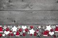 Christmas decoration border in white and red on grey wooden back