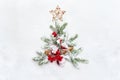 Christmas decoration. Branch christmas tree, christmas toys, star, red berries and cones spruce on snow. Top view, flat lay Royalty Free Stock Photo