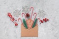 Christmas decoration in a brown craft envelope. Christmas composition. Gray concrete grunge background. Top view, flat lay