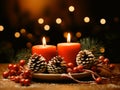 Christmas decoration with burning candles and fir cones on wooden table over red background Royalty Free Stock Photo