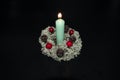 New Year decoration with a candle made of lichen, cones and berries