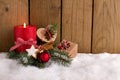Christmas decoration - Candle and presents in the snow Royalty Free Stock Photo