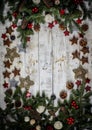 Christmas decoration composition. Frame made of fir branches, pinecones and berries on the wooden board