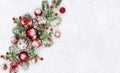 Christmas decoration. Cones pine, twigs christmas tree, red balls, red berries on snow with space for text. Top view, flat lay Royalty Free Stock Photo