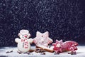 Christmas decoration and cookies.Woman hand sprinkling sugar on a cookies. Flour and spices for a baking on a dark backg Royalty Free Stock Photo