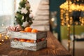 Christmas decoration. Christmas cooking. Dough, flour, cookies, tangerines, cup, mug, christmas ligths. box with fruit, opels on