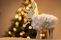 Christmas decoration, cute reindeer, bokeh, lights and tree in background Royalty Free Stock Photo