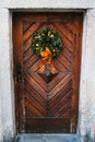 Christmas decoration of the door with a beautiful traditional wreath. Celebrating Christmas, decorating the house. Royalty Free Stock Photo