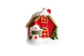 Christmas decoration-a fabulous ceramic house with a snowman, light from the window, a Christmas tree and snow.  Isolate Royalty Free Stock Photo