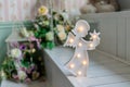 Christmas decoration. Figure of a little angel with star in hands isolated.angel lamp, decor for kids, wooden lamp in Royalty Free Stock Photo