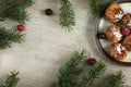 Christmas decoration with fir branches and sweets. Wooden gray background, selective focus with copy space Royalty Free Stock Photo