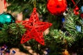 Christmas decoration on fir, red star hanging like decoration on Royalty Free Stock Photo