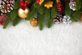 Christmas decoration on fir tree branch closeup, gifts, xmas ball, cone and other object on white blank space fur, holiday concept Royalty Free Stock Photo