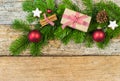 Christmas decoration with fir tree branch, gift box on wood background Royalty Free Stock Photo