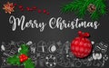 Christmas decoration with fir tree, cone, holly berry, star anise, red ornate christmas ball on black chalkboard Royalty Free Stock Photo