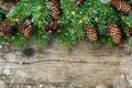 Christmas decoration of fir tree and conifer cone on textured wood background, magic snow effect Royalty Free Stock Photo
