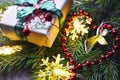 Christmas decoration with fir tree,gift box,garland lights and pine cones on old wooden background.Winter holidays,Merry Ch