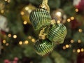 Christmas decoration in the form of green curls on a blurred background of the Christmas tree. The concept of new year and