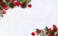 Christmas decoration. Frame of cones pine, twigs christmas tree, red berries and apples on snow with space for text. Top view, Royalty Free Stock Photo