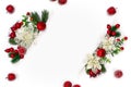 Christmas decoration. Frame of white openwork flowers poinsettia, branch christmas tree, red berries, apples and white paper card Royalty Free Stock Photo