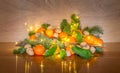 Christmas Decoration with Fresh Mandarins, Walnuts and Fairy Lights